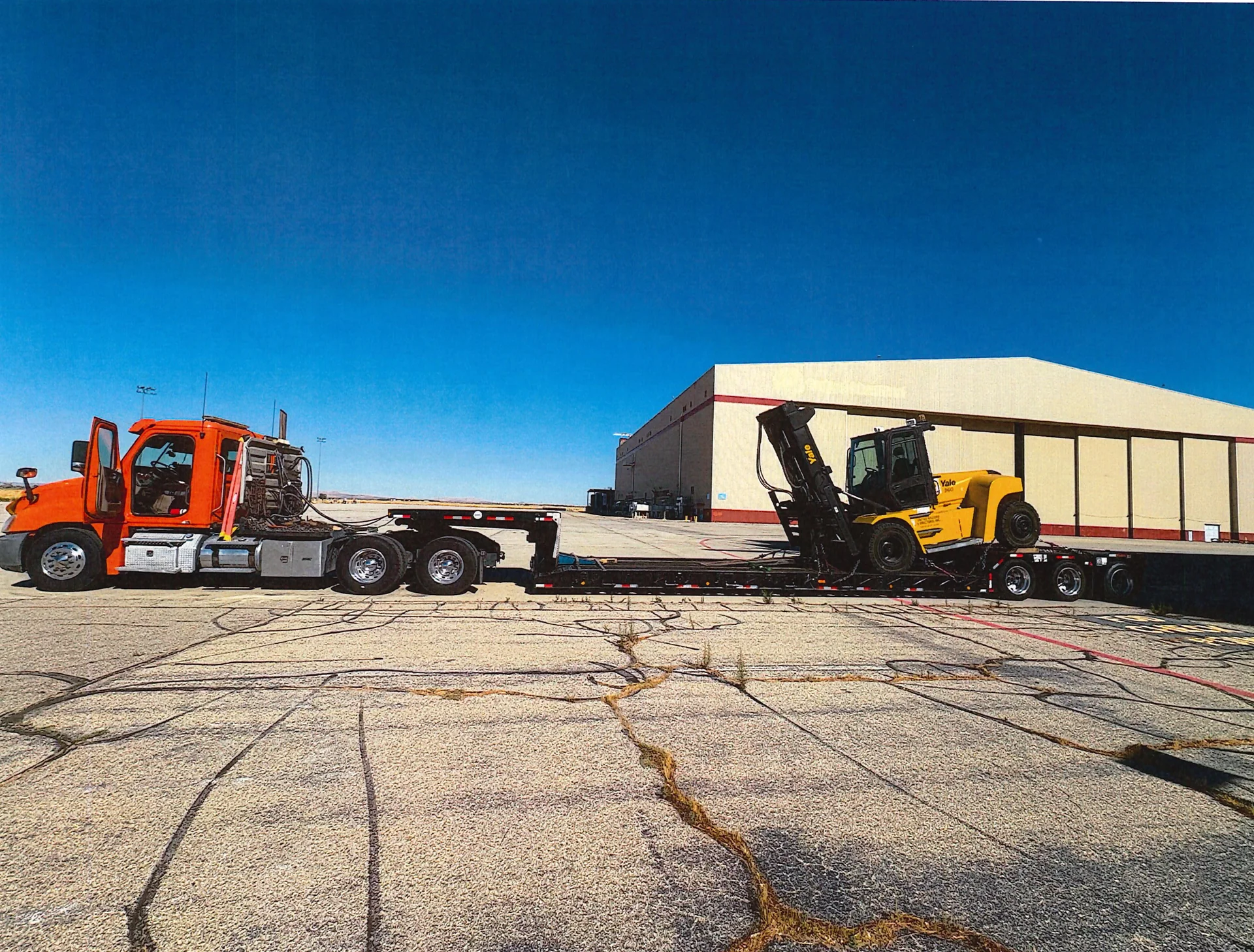 Bowers truck and low-deck trailer carrying a forklift