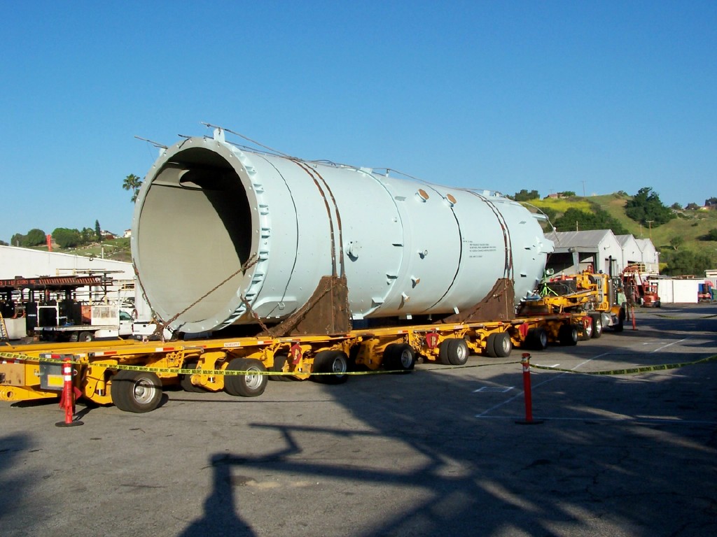 Specialized vessel positioned on a multi-axle transport trailer