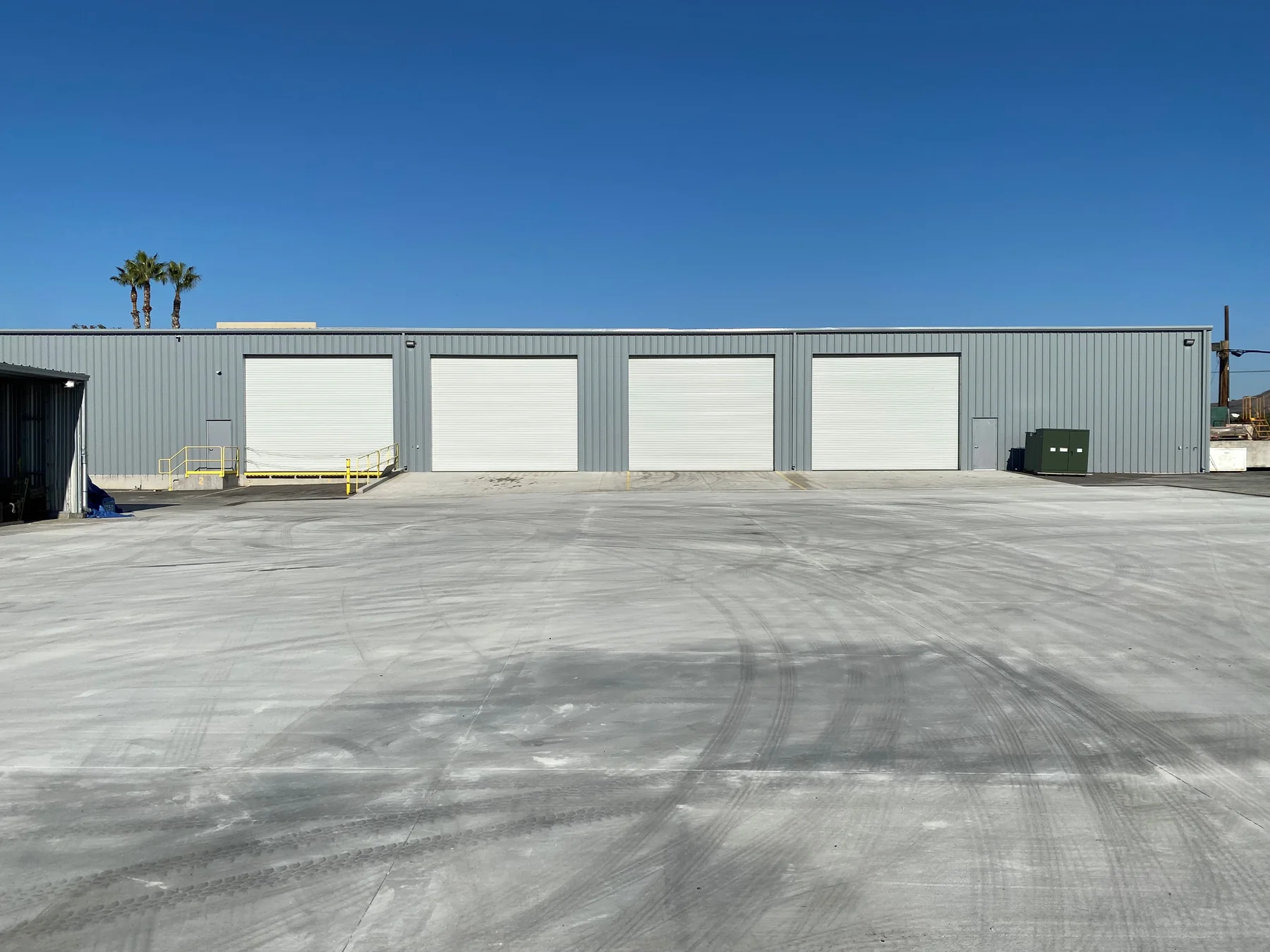 URE’s Walnut warehouse exterior, with roll-up loading doors and a paved yard